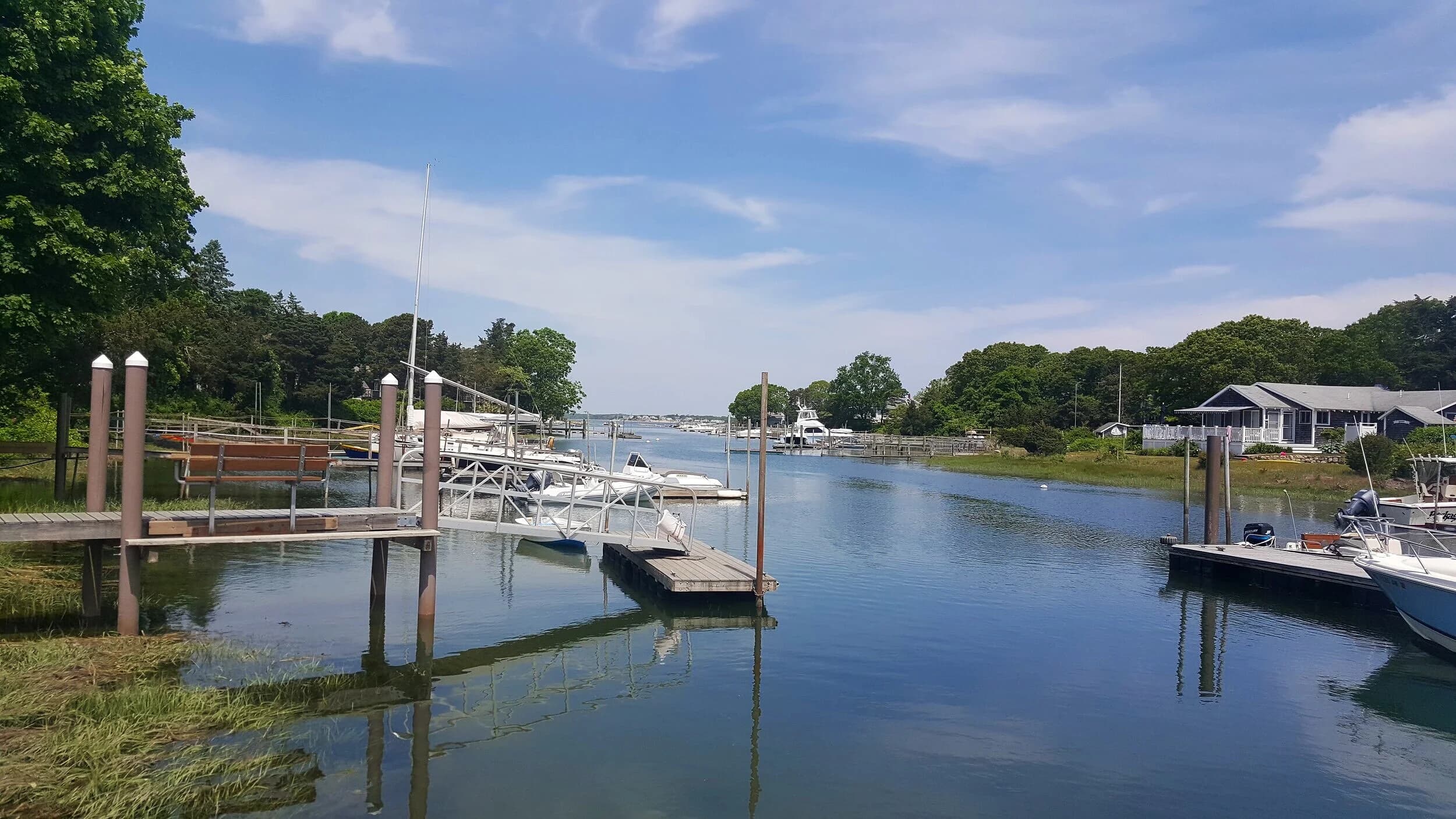 Floating docks along the Pocasset River shoreline at Scallop Bay Marina